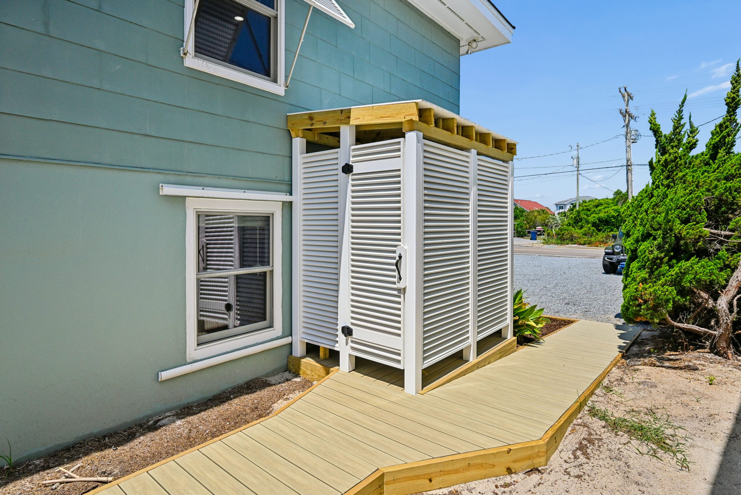 Spacious outdoor shower with hot and cold water and changing area.